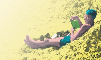 Man-reading-on-a-beach-007