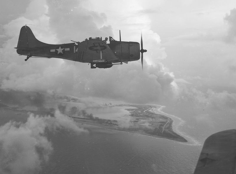 A_Douglas_SBD_Dive_Bomber_over_Wake_Island,_1943