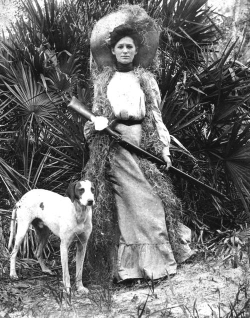 Woman with gun and dog 1910