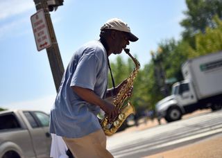 488793279-man-plays-a-saxophone-on-the-street-in-washington-dc-on.jpg.CROP.promo-xlarge2