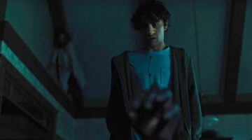 A scene from Hereditary illustrating a figure hidden in the background